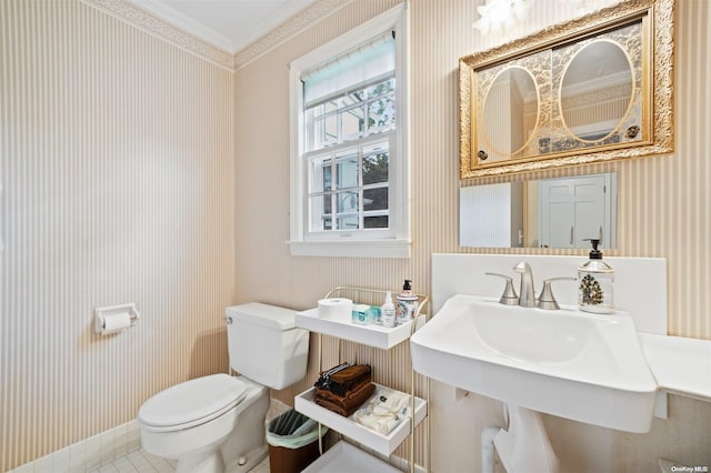 bathroom with crown molding, sink, tile patterned flooring, and toilet