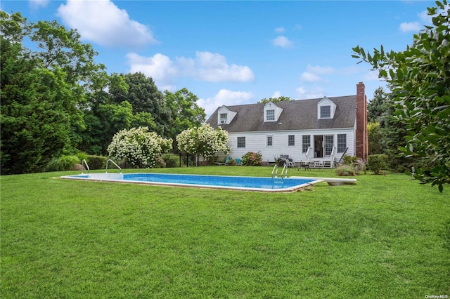 rear view of property featuring a yard