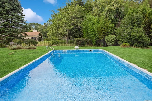 view of pool with a lawn