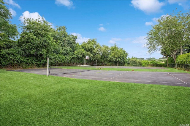 view of sport court featuring a yard and tennis court