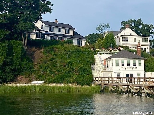 back of property with a water view