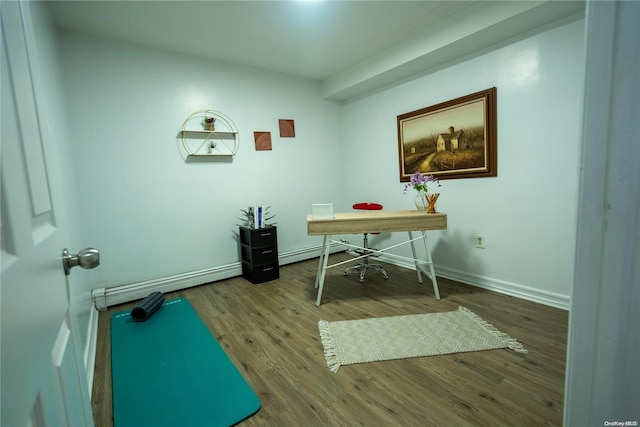 home office with wood-type flooring and baseboard heating