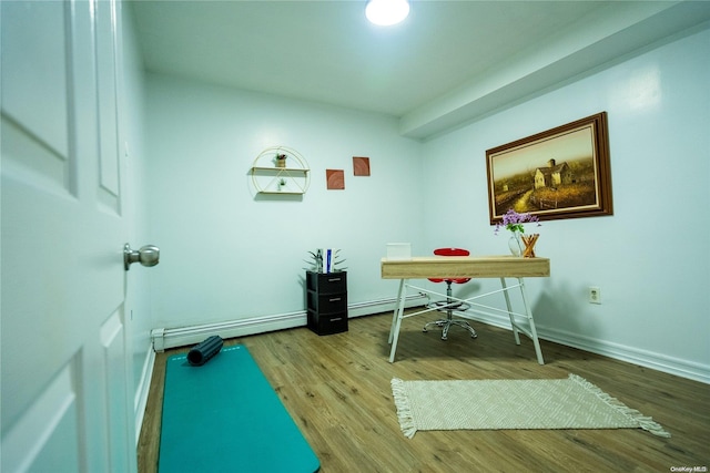 office with wood-type flooring and a baseboard heating unit