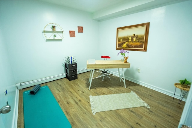 office area with a baseboard radiator and hardwood / wood-style flooring