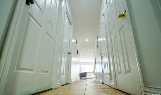 corridor featuring light tile patterned floors