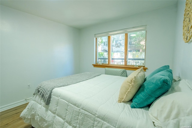 bedroom with hardwood / wood-style flooring