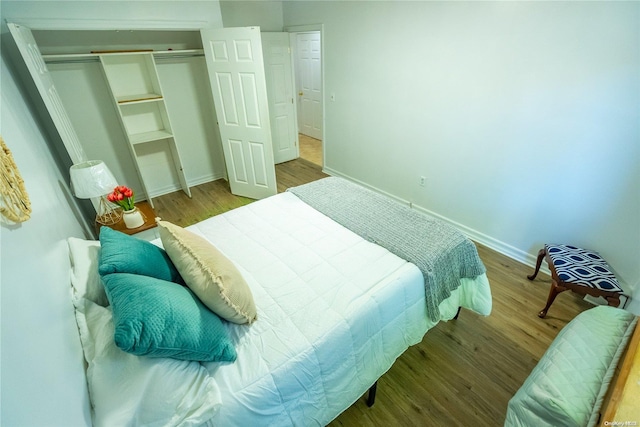 bedroom with hardwood / wood-style flooring and a closet