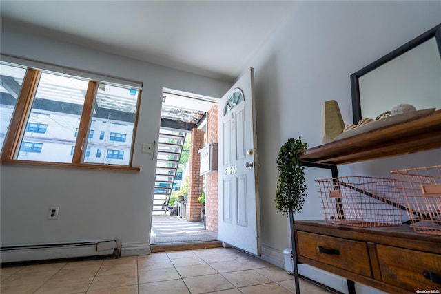 foyer with light tile patterned floors and baseboard heating