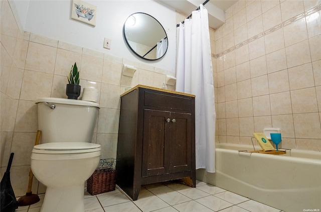 bathroom with tile patterned flooring, shower / bath combo, toilet, and tile walls