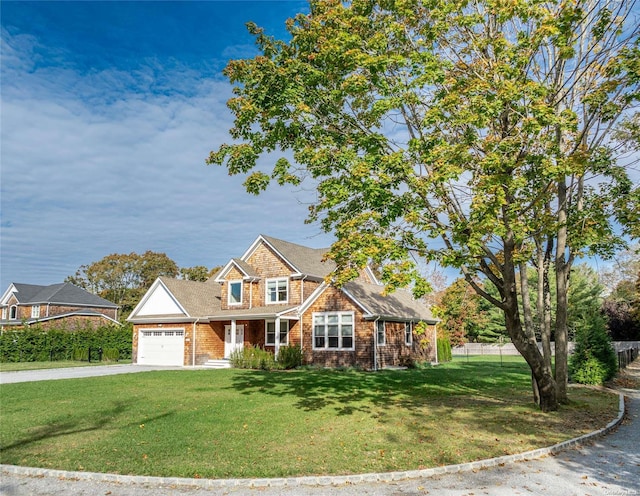 view of front of house featuring a garage and a front yard