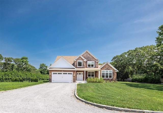 view of front of home with a front lawn and a garage