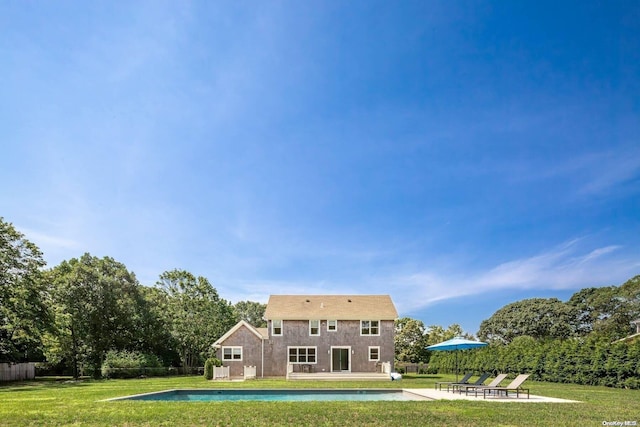 rear view of property with a yard