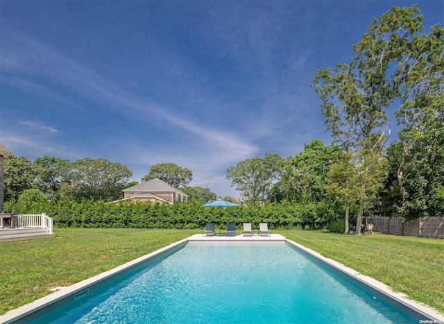 view of swimming pool featuring a lawn