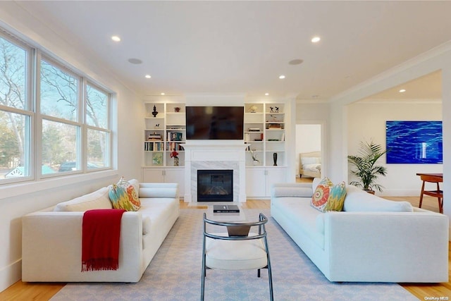 living room featuring crown molding and light hardwood / wood-style flooring