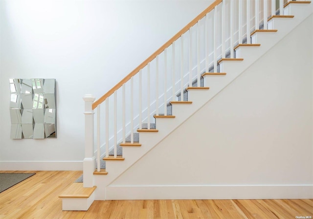 stairs with hardwood / wood-style flooring