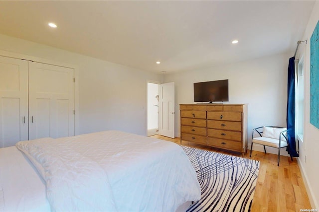 bedroom featuring light hardwood / wood-style floors and a closet