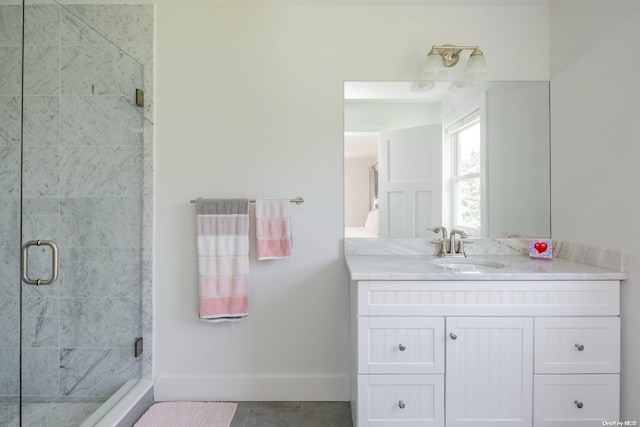 bathroom with vanity and a shower with shower door