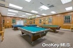 rec room featuring wooden walls, carpet floors, and pool table