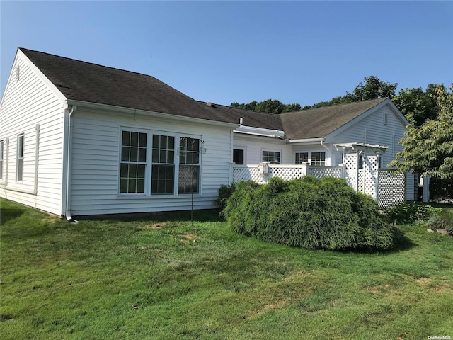 rear view of house with a yard