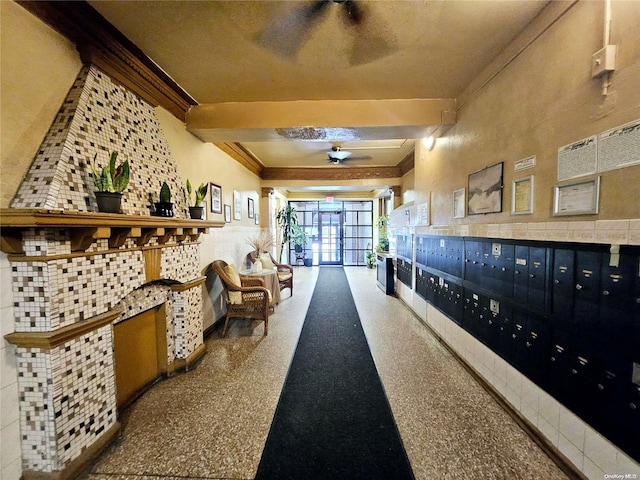 interior space featuring beam ceiling, mail boxes, and crown molding