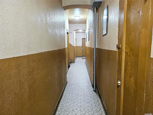 hall featuring light tile patterned floors