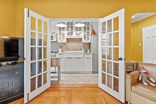 pantry featuring french doors and sink