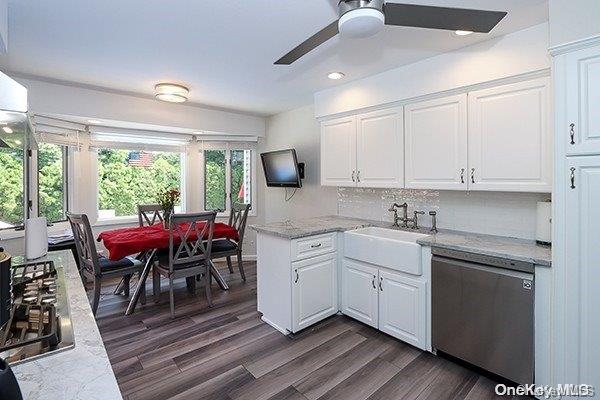 kitchen featuring sink, ceiling fan, dishwasher, and white cabinetry