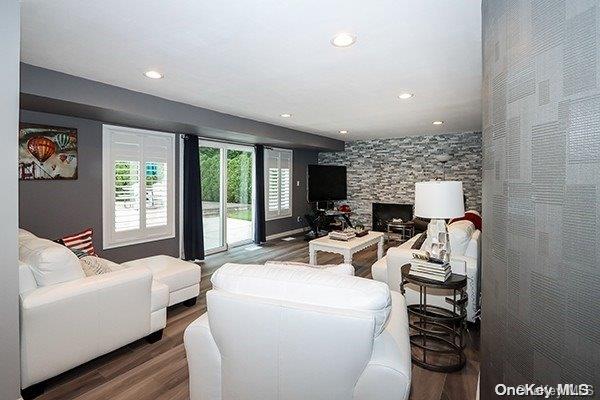 living room with hardwood / wood-style flooring and a fireplace