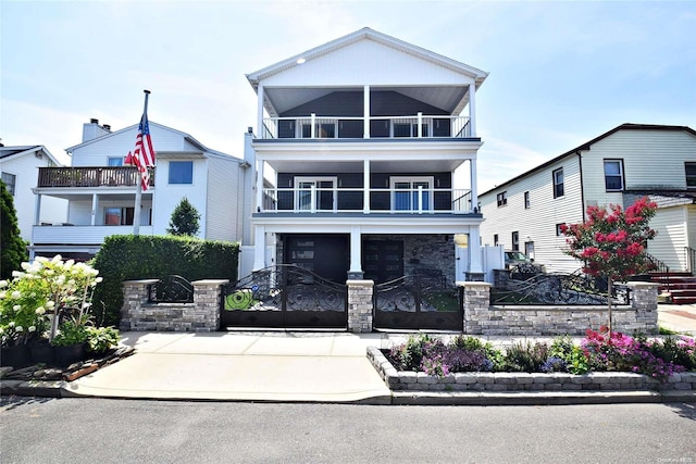 46 E Fulton St, Long Beach, NY 11561 - view of front of property with a balcony, a gate, a fenced front yard, and driveway