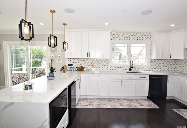 kitchen with black appliances, sink, hanging light fixtures, white cabinets, and light stone counters