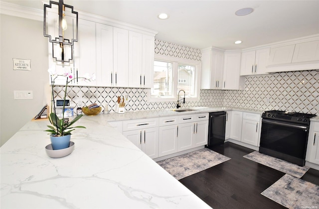 kitchen with black appliances, crown molding, white cabinetry, hanging light fixtures, and light stone counters