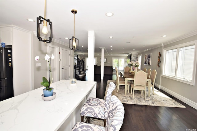 dining area featuring ornamental molding and dark hardwood / wood-style floors