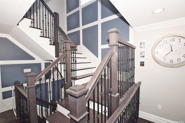 stairway featuring crown molding and hardwood / wood-style floors