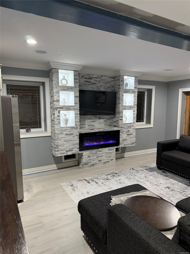 living room with ornamental molding and a fireplace