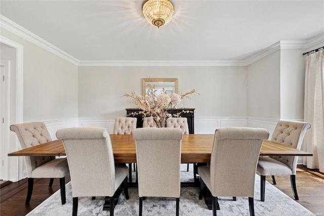 dining room featuring a chandelier, wood-type flooring, and crown molding