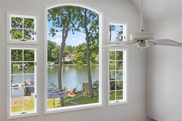 doorway to outside featuring a wealth of natural light, ceiling fan, a water view, and vaulted ceiling