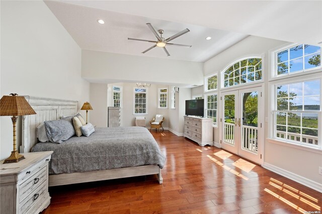 bedroom with access to exterior, french doors, ceiling fan with notable chandelier, and hardwood / wood-style floors