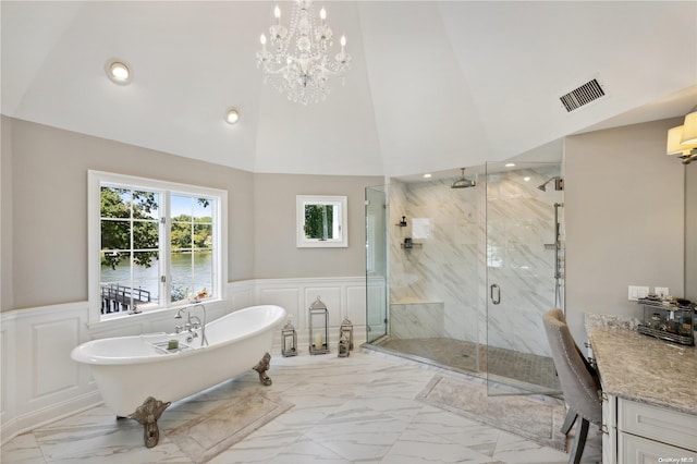 bathroom featuring vanity, separate shower and tub, lofted ceiling, and a notable chandelier