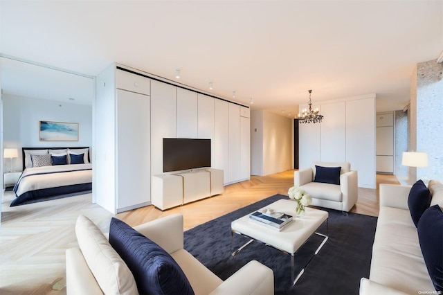 living room with a notable chandelier and light parquet floors