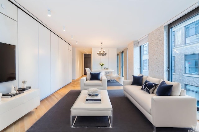 living room featuring light hardwood / wood-style floors and an inviting chandelier