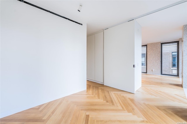 unfurnished room featuring light parquet flooring