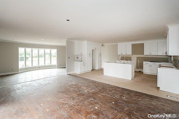 kitchen featuring a center island, white cabinets, and light hardwood / wood-style flooring