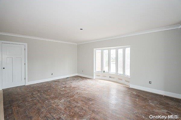 spare room with dark hardwood / wood-style floors and ornamental molding