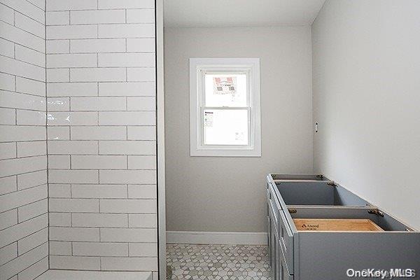 127 Berkshire Rd, Rockville Centre, NY 11570 - bathroom featuring tile patterned flooring and baseboards
