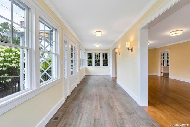 hallway featuring crown molding and hardwood / wood-style flooring