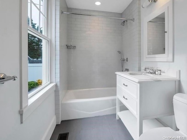 full bathroom with tile patterned flooring, vanity, toilet, and tiled shower / bath