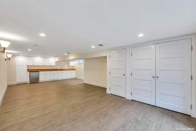 basement featuring light hardwood / wood-style flooring