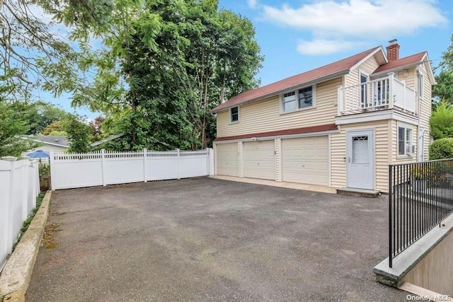 exterior space featuring a balcony and a garage