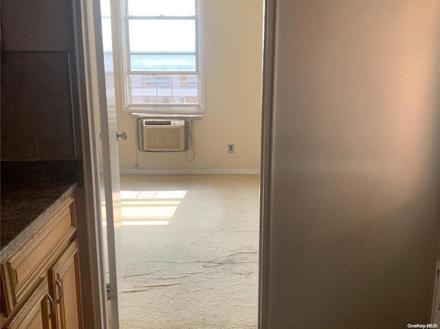 corridor featuring carpet floors and a wall mounted air conditioner