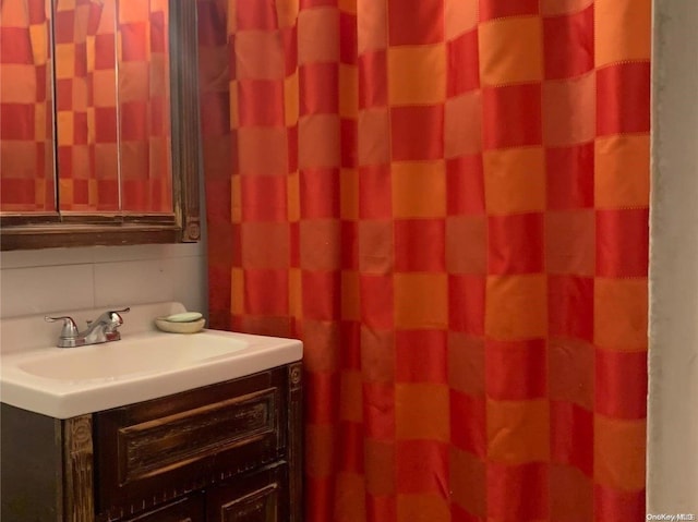 bathroom with vanity and tasteful backsplash